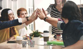 group of people bringing their hands together