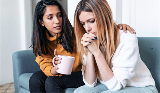 a woman comforting another woman