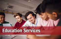 Five individuals are looking at something on a table, text reads: Education Services